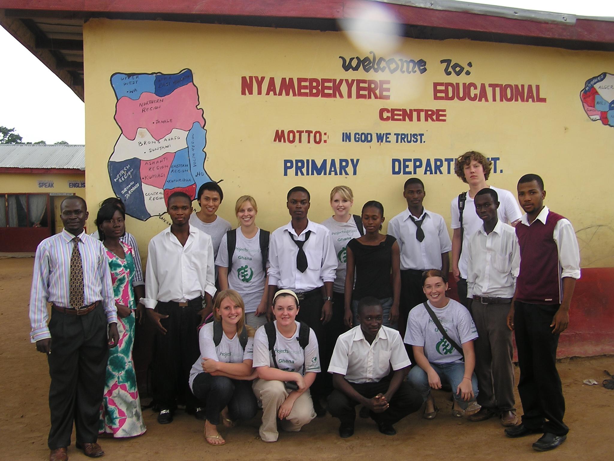 A group photo of students and Projects Abroad volunteers before their teaching IT class in Ghana. Projects Abroad volunteers and their students outside their volunteer IT teaching placement in Ghana.